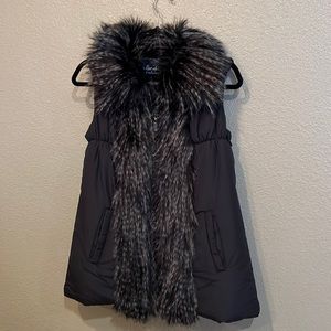 Black polyester shell vest, with faux fur trim.